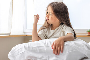 Adorable little girl in her bed early in the morning.