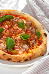 Italian pizza with tuna, olives and basil close-up on the table. horizontal view from above