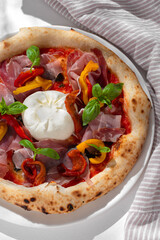 Close up view on Appetizing with burrata cheese, tomatoes and basil. Pizza in composition