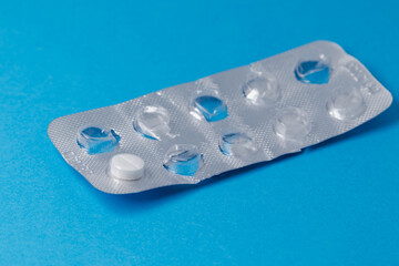 A pack of medicine with one tablet left. Medicine use, used medical pill blister on blue...