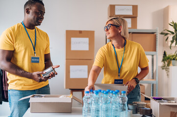 Group of multiracial volunteers working in community charity donation center