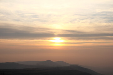 Fototapeta na wymiar Sunset over the huge mountains.