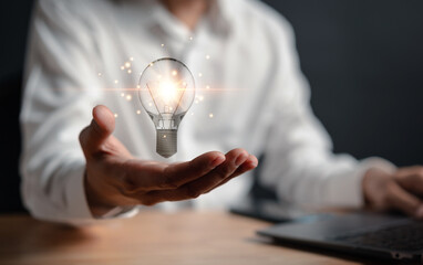 Obraz na płótnie Canvas Great inspiration and innovation new beginning. creative smart thinking ideas and innovation. Businessman holding virtual lightbulb for presenting new ideas concept.