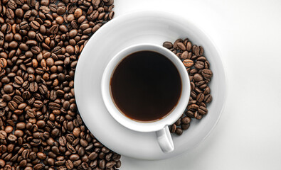 Cup of coffee and coffee beans, flat lay.