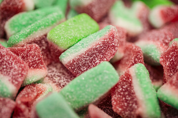 Gummy candies in the form of watermelons in sugar, macro shot.