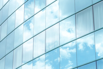 White clouds reflecting in simple modern generic office building square windows, skyscraper exterior, bright blue white background, contemporary corporate architecture backgrounds, nobody, no people