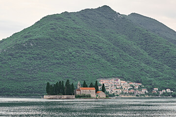 church on small island in the middle of a lake in europe