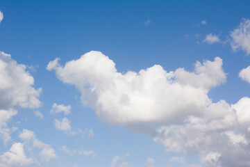 Naklejka na ściany i meble Shaped cloud on blue sky