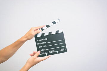 Hands holding a empty film making clapperboard or movie slate on a white background 