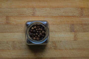 Fototapeta na wymiar Balls of pepper on wooden background in kitchen.