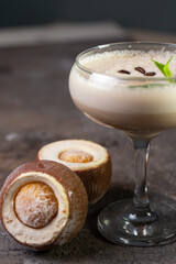 cocktail and coconut dessert on a dark background