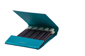 Close up view of matches in green pack on white background isolated.