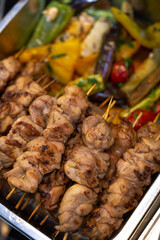 chicken kebab on a wooden stick in marmite top view