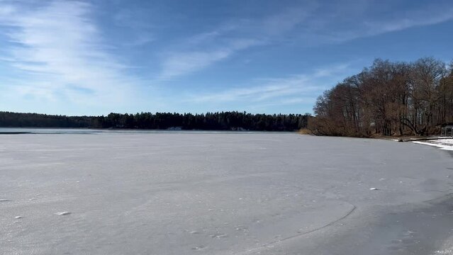 Sliding view over a frozen lake during the winter. Sunny day with nice weather. Peaceful and calm. 4K movie. M&auml;laren, Stockholm, Sweden, Europe.