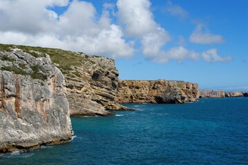 Scenic rocks on Atlantic coast near Cabo de Sao Vicente Cape in the Algarve, Portugal, on bright summer day