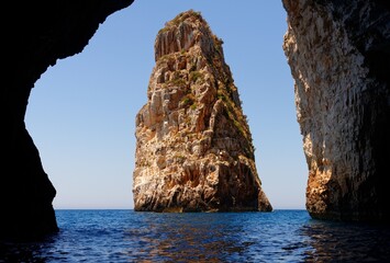 Ortholithos Rock in sea near Paxos island, Greece, seen through the cave entrance