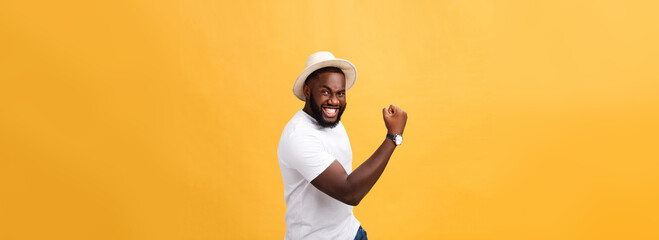 Handsome young Afro-American man employee feeling excited, gesturing actively, keeping fists clenched, exclaiming joyfully with mouth wide opened, happy with good luck or promotion at work