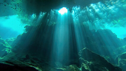 light beam from above, seen scuba diving in chac-mool cenote near cancun mexico