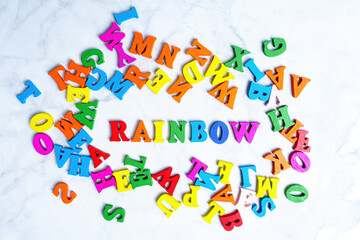 RAINBOW word made from multicolored wooden letters
