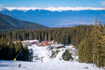 Winter landscape with panorama of Bansko above the clouds. Famous ski resort in Bulgaria. View of...
