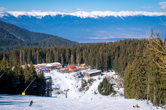 Winter landscape with panorama of Bansko above the clouds. Famous ski resort in Bulgaria. View of the ski slopes and the Pirin Mountains