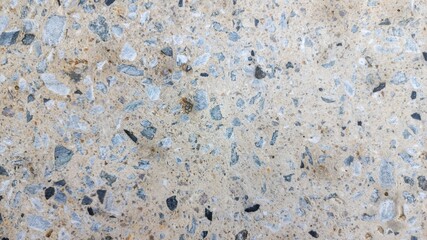 Concrete background with pebbles on surface