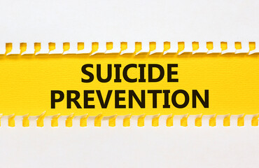 Suicide prevention symbol. Concept words Suicide prevention on yellow and white paper. Beautiful...