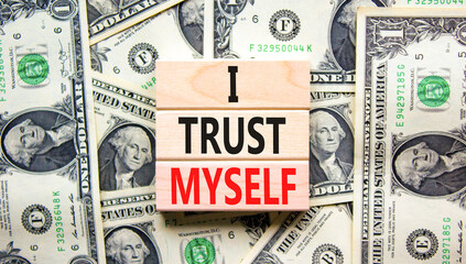 I trust myself symbol. Concept words I trust myself on wooden blocks. Dollar bills. Beautiful...