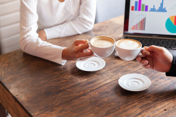 Two businessmen talking in a board room about joint business and summarize the company's profits with a graph showing successful performance. A colleague reviewed the results of the quarterly report.