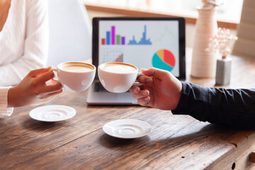 Two businessmen talking in a board room about joint business and summarize the company's profits with a graph showing successful performance. A colleague reviewed the results of the quarterly report.