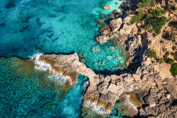 Beautiful summer seascape from air. Turquoise sea water with waves and rocks from top view, Islands...