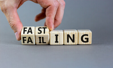 Fasting or failing symbol. Concept words Fasting or Failing on wooden cubes. Businessman hand. Beautiful grey table grey background. Business fasting or failing concept. Copy space.