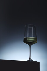 White wine in a transparent glass in low key
