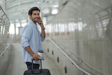 Handsome Arab Man Relaxing With Smartphone While Waiting For Flight In Airport, Smiling Middle Eastern Male Traveller Using Mobile Phone In Terminal, Booking Hotel Online Or Browsing Internet