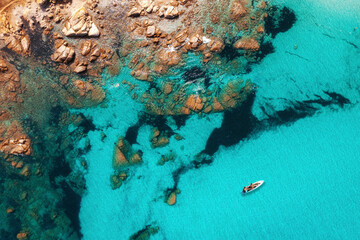 Beautiful summer seascape from air. Turquoise sea water with sup and rocks from top view, Islands of sardinia in Italy. Vacation background