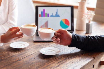 Two businessmen talking in a board room about joint business and summarize the company's profits with a graph showing successful performance. A colleague reviewed the results of the quarterly report.