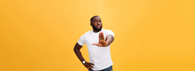 Plakat Portrait shock and annoyed displeased young man raising hands up to say no stop right there isolated orange background. Negative human emotion, facial expression, sign, symbol, body language