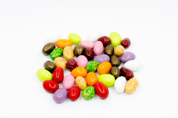 Colorful candy canes. Dragee chocolate candies isolated on white background.
