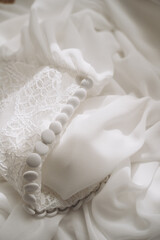 Ñobody. Female white  clothing on hangers. Beautiful details of bridesmaid robes. 
Feather, lace.