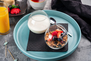 Granola with yogurt, nuts and fresh berries in a glass. Muesli with raspberries, strawberries, blackberries and blueberries