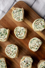 Homemade Pinwheel Tortilla Appetizers with Bacon, Spinach, Green Onion and Cream Cheese, top view. Flat lay, overhead, from above.