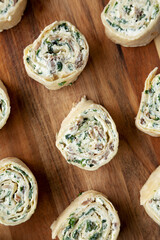 Homemade Pinwheel Tortilla Appetizers with Bacon, Spinach, Green Onion and Cream Cheese, top view. Flat lay, overhead, from above.