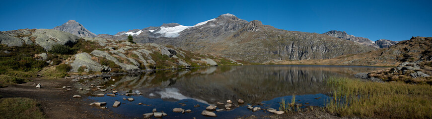 a beautiful panoramic view of the lac blanc with the highest summit of the Vanoise, the dent parrachee, in the distance