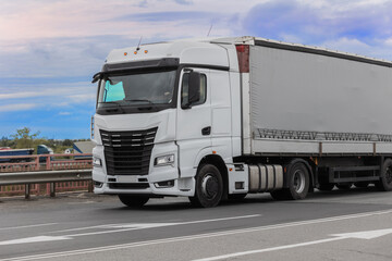 Fototapeta na wymiar European truck moves on a country highway