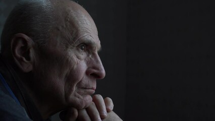 Side view of sad widowed senior man with pensive look. Mental health and grandparents care concept.