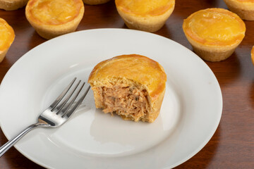 Empadinha de frango, typical appetizer of Brazilian cuisine, visible filling
