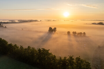 Sunrise over farmland and fog over the fields