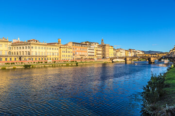 Fototapeta premium Florence, Italy. Scenic view of the embankment and bridges over the Arno River: Santa Trinity and Ponte Vecchio