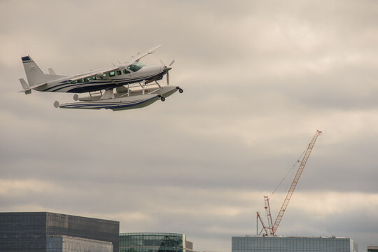 Seaplane flying over the city of Boston, Massachusetts, after taking off.