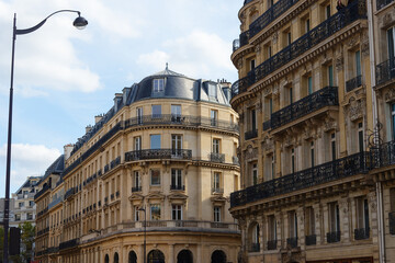 The facades of traditional French houses with typical balconies and windows. Paris.